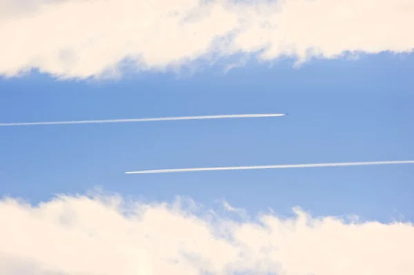 stock image Airplane vapour contrails against vivid blue sky