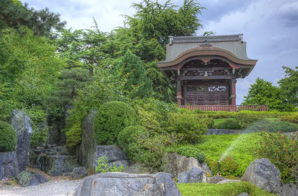 Japanese water garden with rock features and pagoda