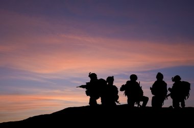 Silhouette of modern troops in Middle East silhouette against be clipart