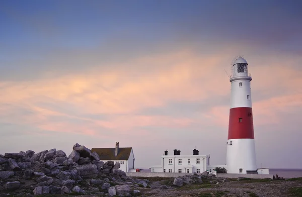 stock image Victorian lighthouse on promontory of rocky cliffs during stunni