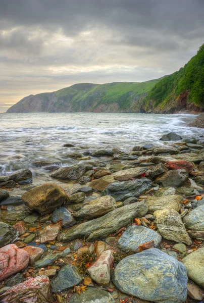 Güzel sıcak canlı gündoğumu okyanus olan kayalıklarla ve kayalar — Stok fotoğraf