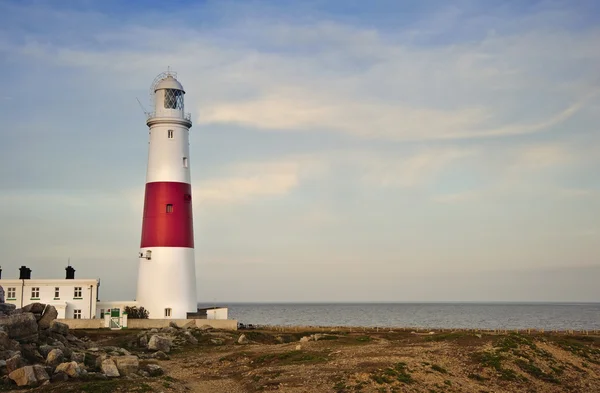 stock image Victorian lighthouse on promontory of rocky cliffs