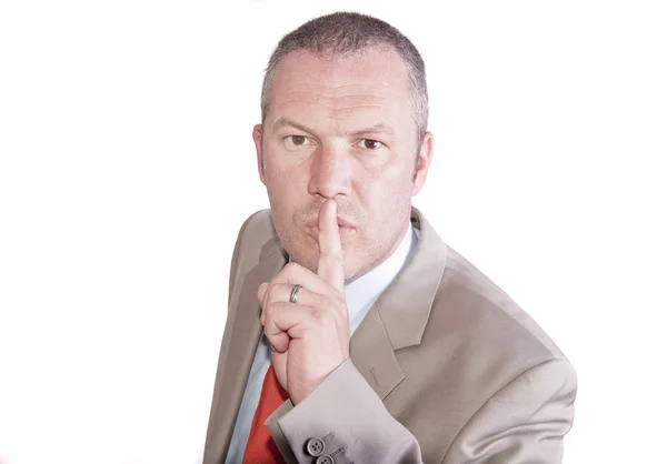 Middle aged businessman in suit makes gesture to be quiet — Stock Photo, Image
