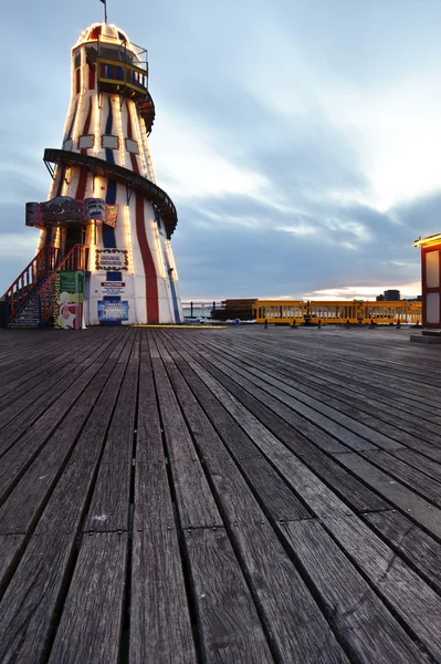 stock image Helter skelter fun fair ride on pier at sunset