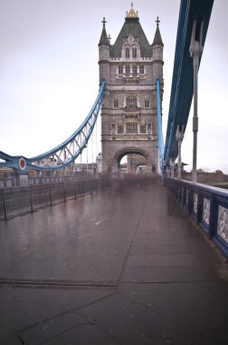 Unusual view of Tower Bridge in London with blurred pedestrians clipart