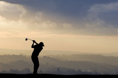 Golfer silhouette against stunning sunset sky clipart