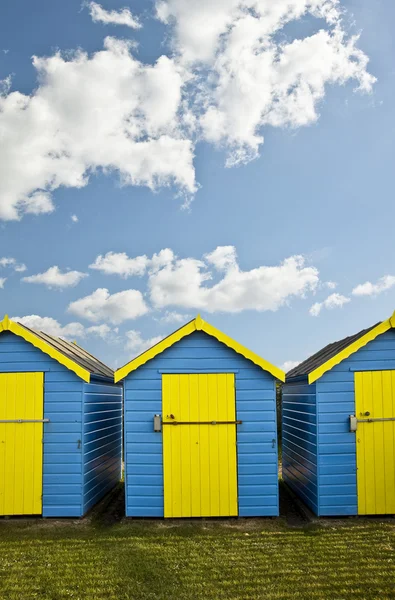 stock image Beach Huts agsinst vibrant blue Summer sky