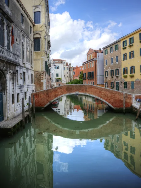 Beautiful reflections of bridge in canal in Venice Italy — Stock Photo, Image