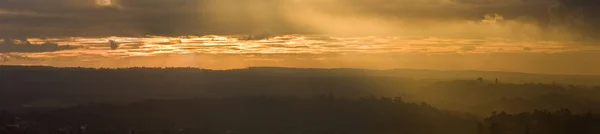 stock image Stunning colorful sunset over countryside landscape