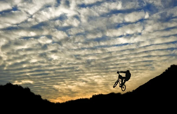 Sporty ekstremalne rower jazda sylwetka wspaniały zachód słońca — Zdjęcie stockowe