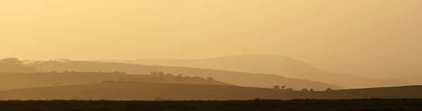 Rolling countryside landscape on hazy Summer evening