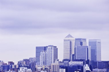 Cold toned image of London financial district representing emotionless busi clipart