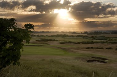 View of sunset across links golf course clipart