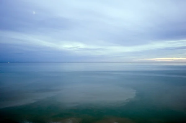 Larga exposición desenfoque del mar por la noche —  Fotos de Stock