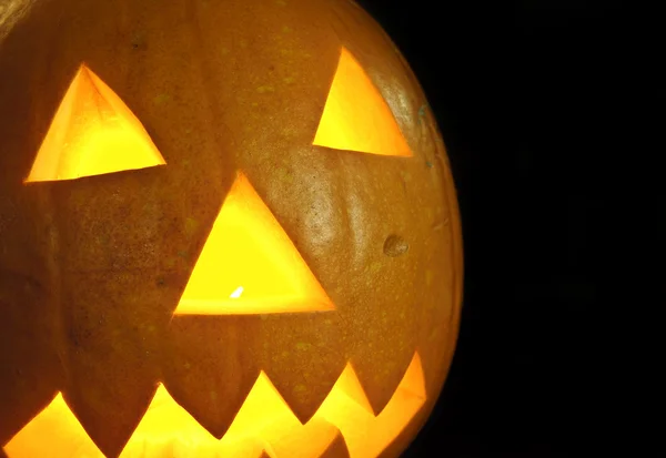 stock image Spooky Halloween pumpkin on black background