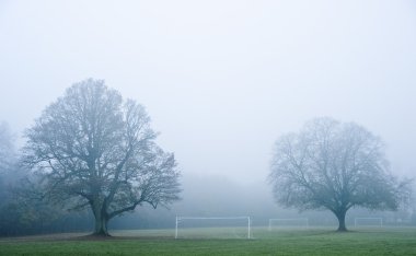 Football soccer pitch on foggy misty morning in Autumn Fall clipart