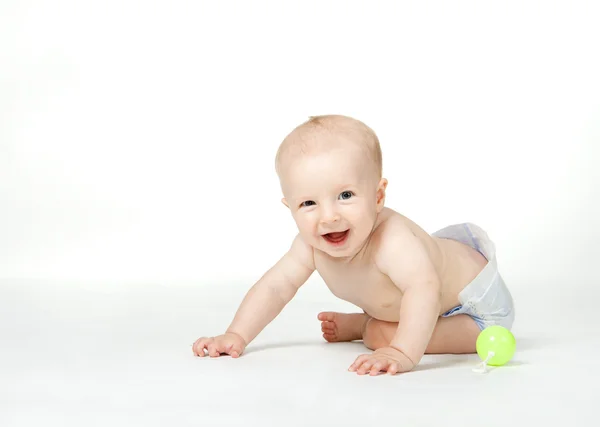 Altı ay çocuk gülümser ve beyaz arka plan üzerinde oturur — Stok fotoğraf