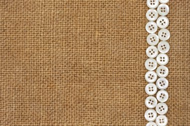 Nacre buttons on fabric texture background clipart