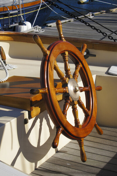 Wheel of a large sailboat in varnished mahogany