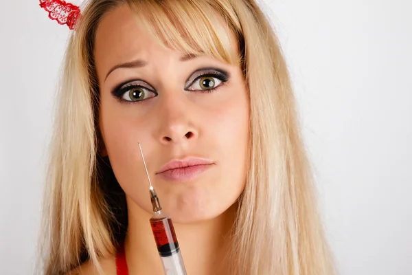 Young woman with a syringe — Stock Photo, Image