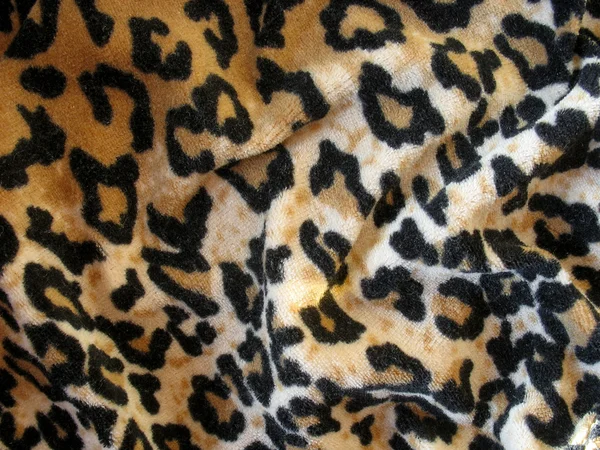 Fleecy brown leopard skin fabric background — Stock Photo, Image