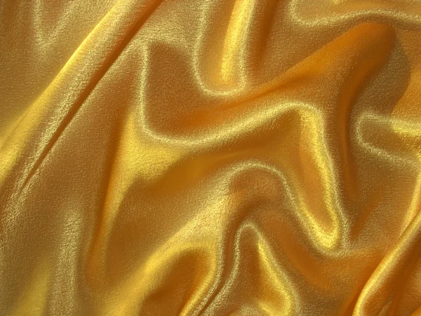 Draped golden (orange) satin fabric — Stock Photo, Image