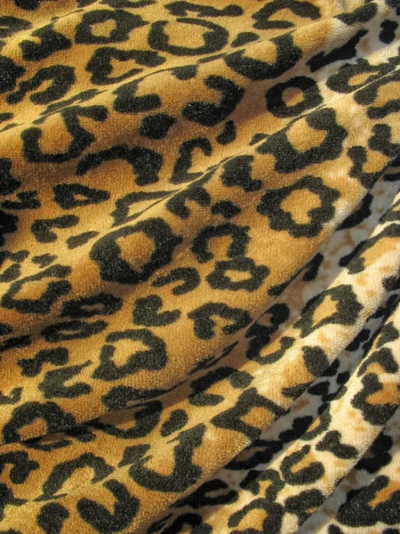 Wollige bruin gedrapeerd leopard huid weefsel — Stockfoto