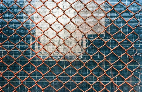 Metal fence on closed down building — Stock Photo, Image