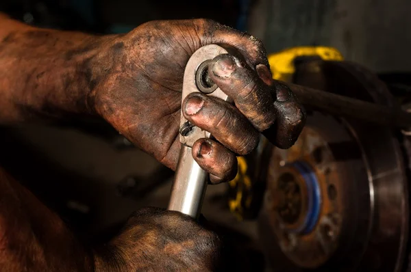 Hard working man with hands full of oil — Stock Photo, Image