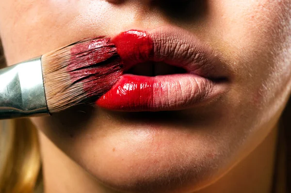 Conceptual makeup with a little bit of red paint