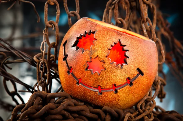 Halloween pumkin cought in the web of chains — Stock Photo, Image