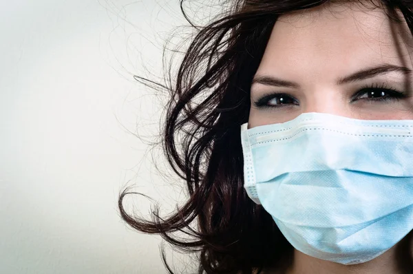 A girl in a protective mask against white isolated background — Stock Photo, Image