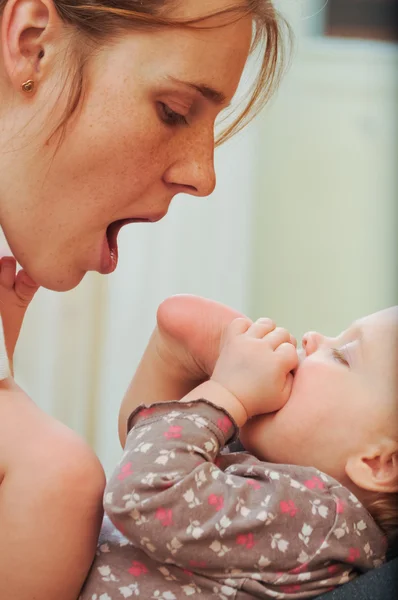 Küçük bebek ile oynarken annesi — Stok fotoğraf