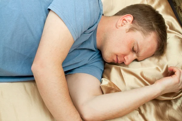 Giovane uomo dormire a letto — Foto Stock