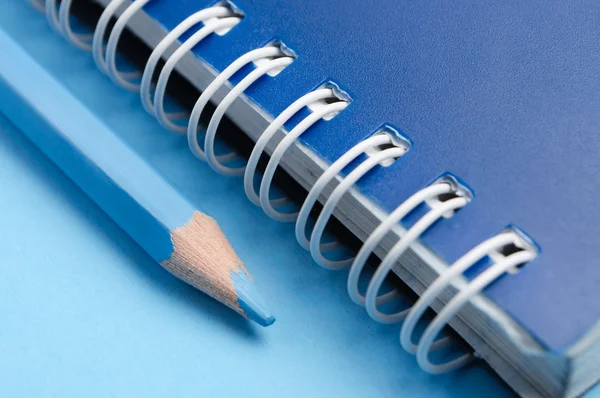Blue pencil and spiral of notebook — Stok fotoğraf