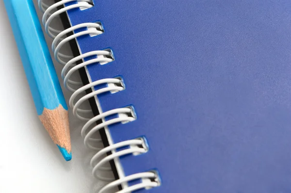 Lápis azul e espiral de notebook — Fotografia de Stock