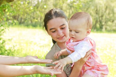 Teenager with a baby in her arms clipart