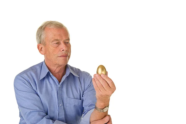 Senior man with golden egg — Stock Photo, Image