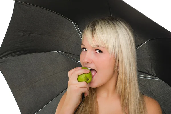 Happy young girl bites a pear — Stock Photo, Image