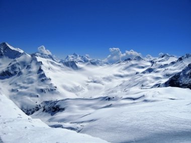 Caucasus mountains under the snow and clear sky clipart
