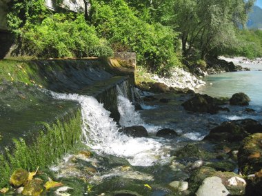 Low and wide waterfall. Abhazia travel clipart