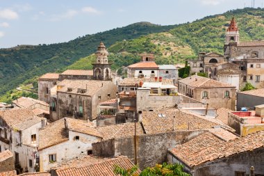 View on ancient tile roofs and tower of Sant Antonio church in Castiglione clipart