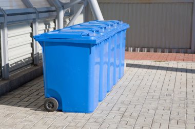 Blue plastic recycling bins clipart