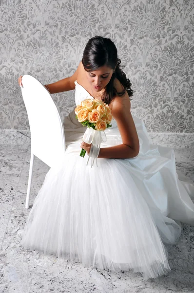 stock image BRIDE LOOKING AT BOUQUET