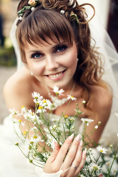 Young happy bride with flowers — Stock Photo, Image