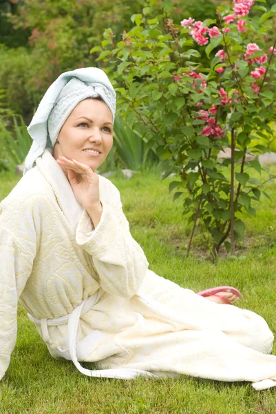Woman in robe on grass — Stock Photo, Image