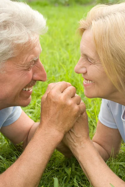 Elderly couple at grass — Stock Photo, Image