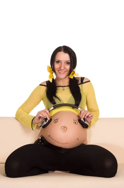 Těhotná žena a sluchátka — Stock fotografie