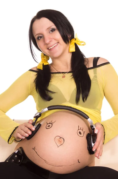 Mujer embarazada y auriculares — Foto de Stock