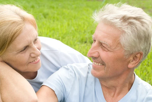 Old couple lying at grass — Stock Photo, Image
